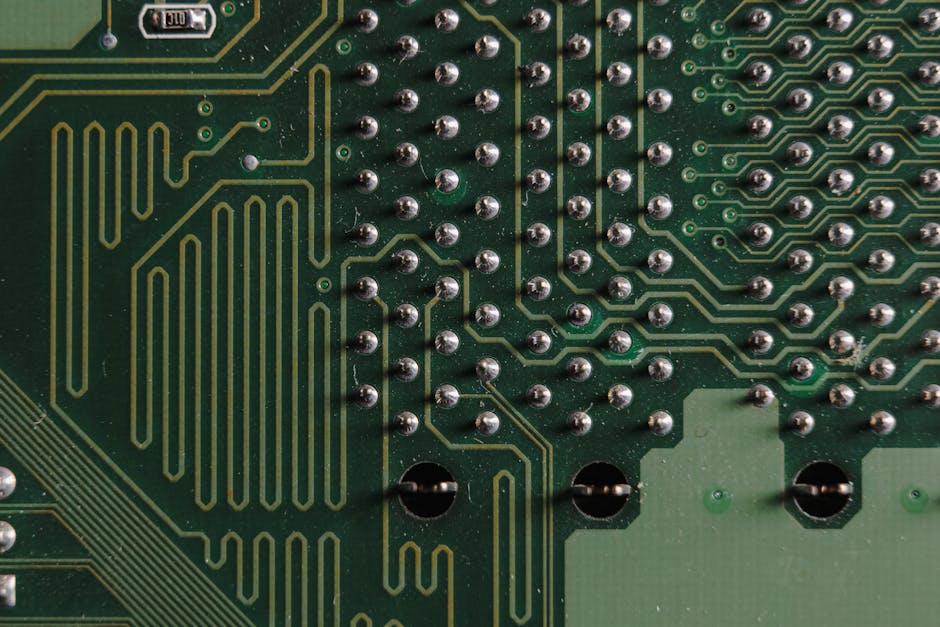 Detailed close-up of electronic circuit board with intricate green patterns and components.